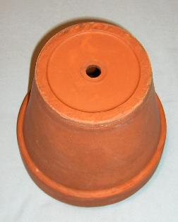 Clay Flower Pot, Upside Down to Show Hole in Bottom
